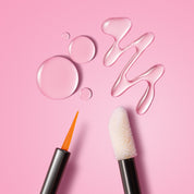 Close-up of Lash Therapy Australia lash and brow serum applicators with precision brush and sponge tip on pink background
