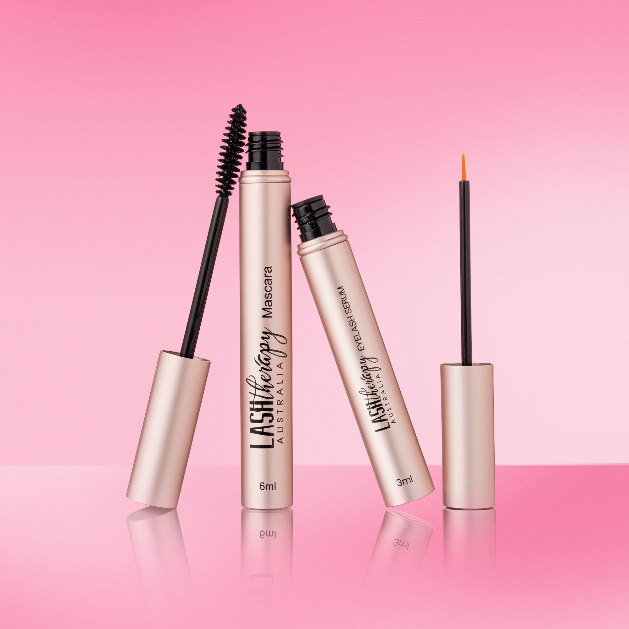 Lash Therapy Australia mascara and lash growth serum with applicators displayed on pink background
